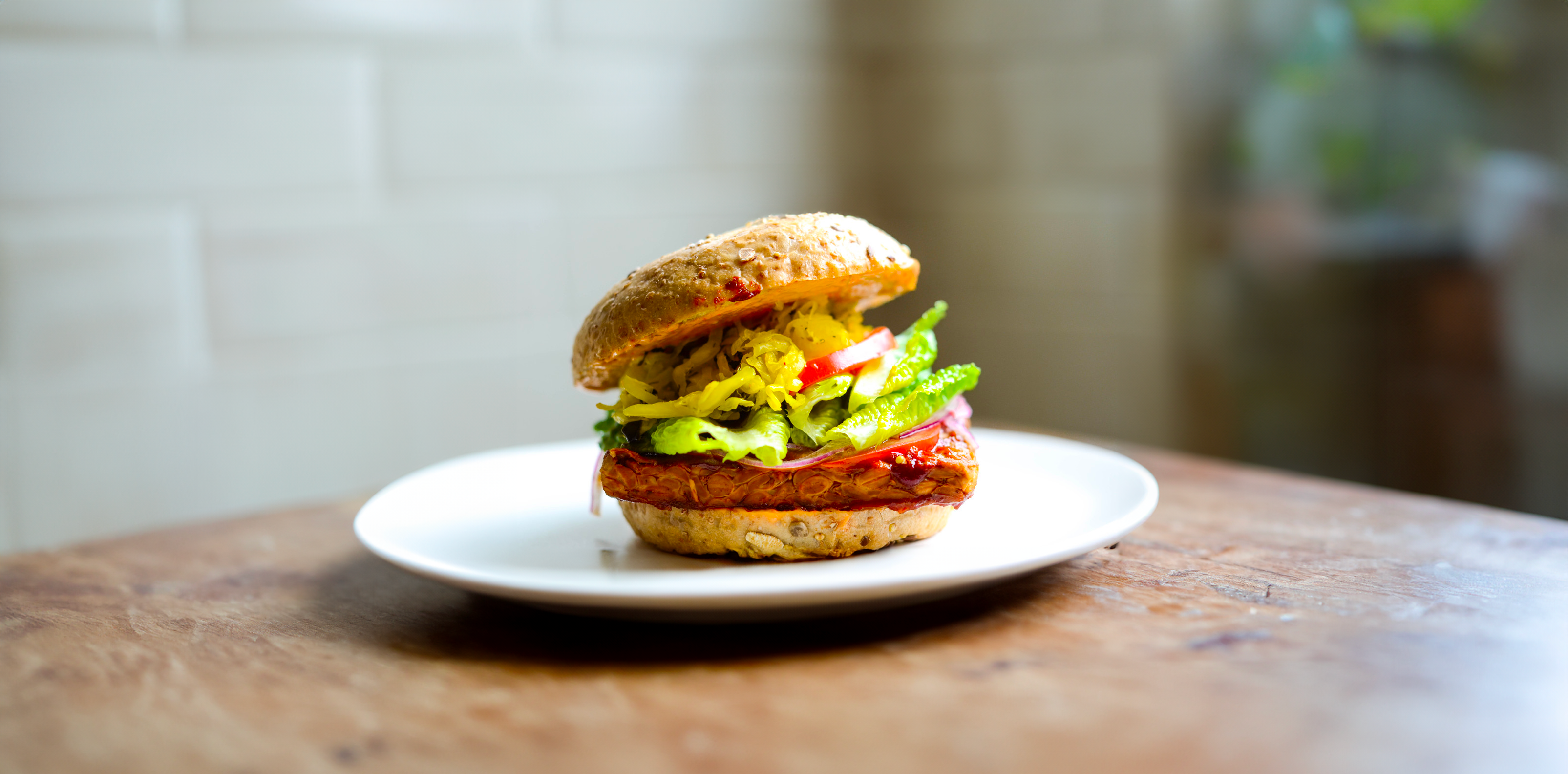 Tempeh Burger au curry, légumes de saison, petit pois, roquette, pousse d’épinard, fanes de betterave ou de radis, cébette, ketjap manis, ananas